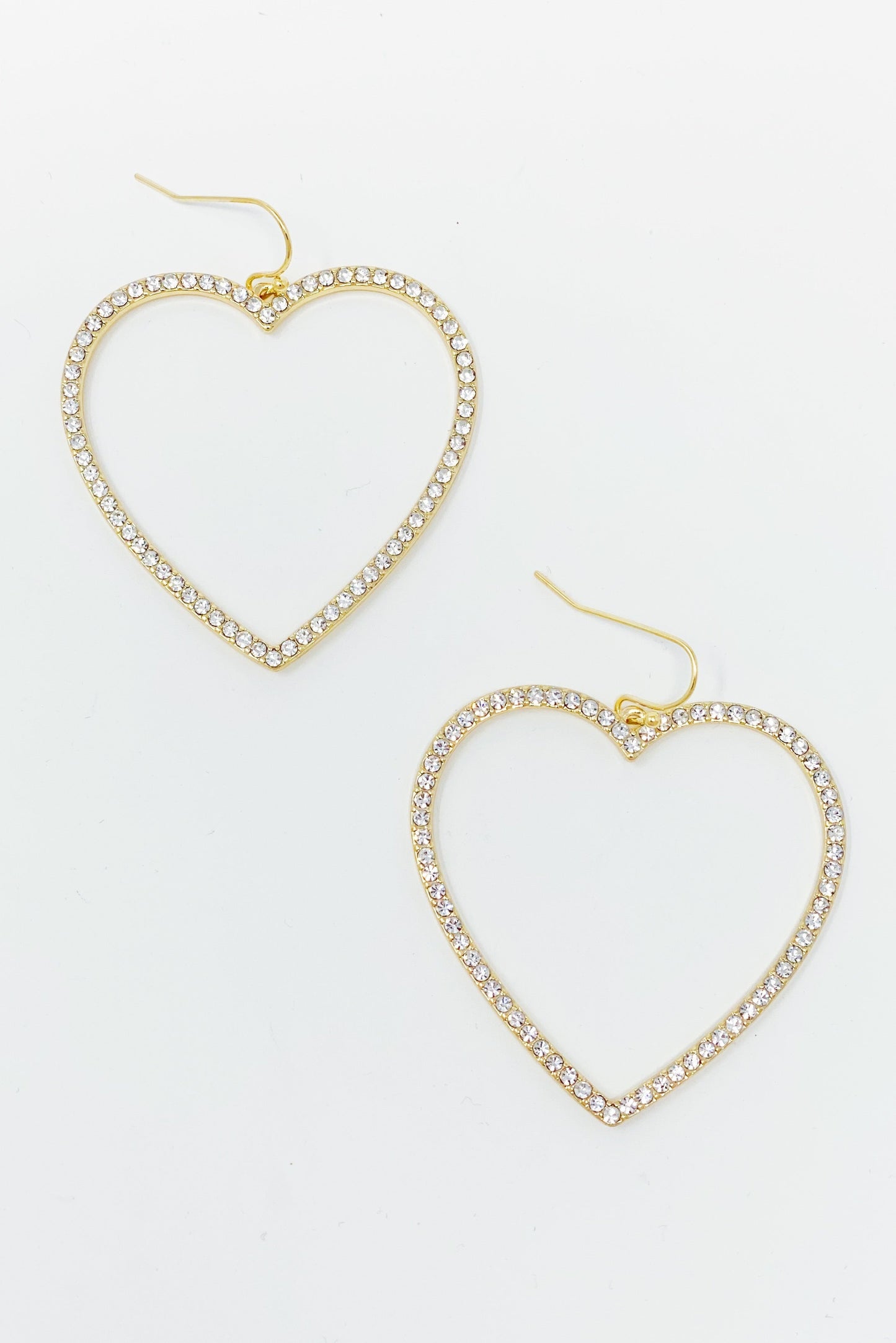 gold dangling heart hoop earrings displayed on white background