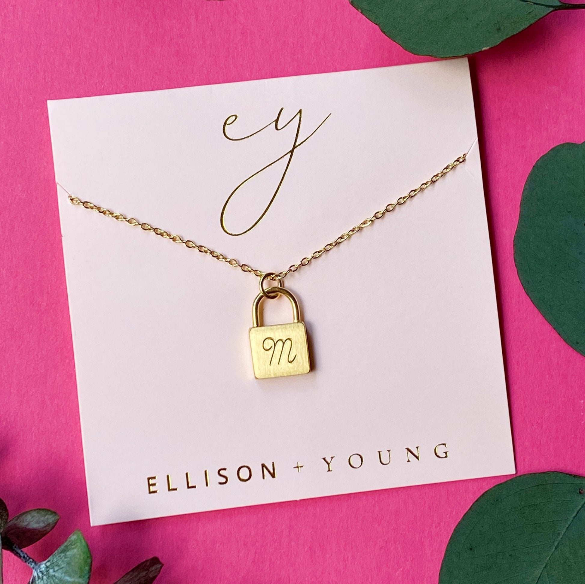 A 'M' initial necklace shown 