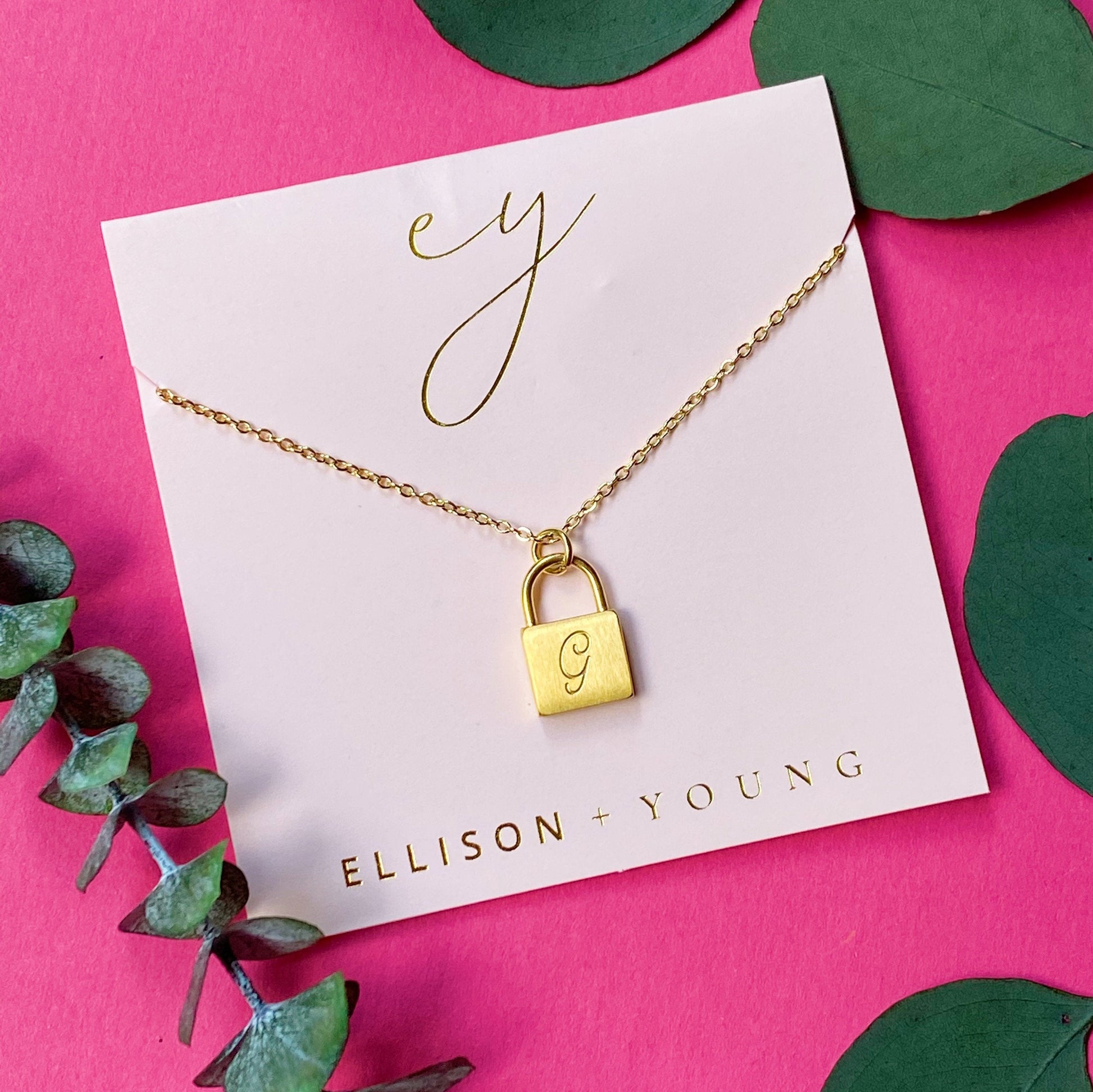 A 'G' initial necklace shown 