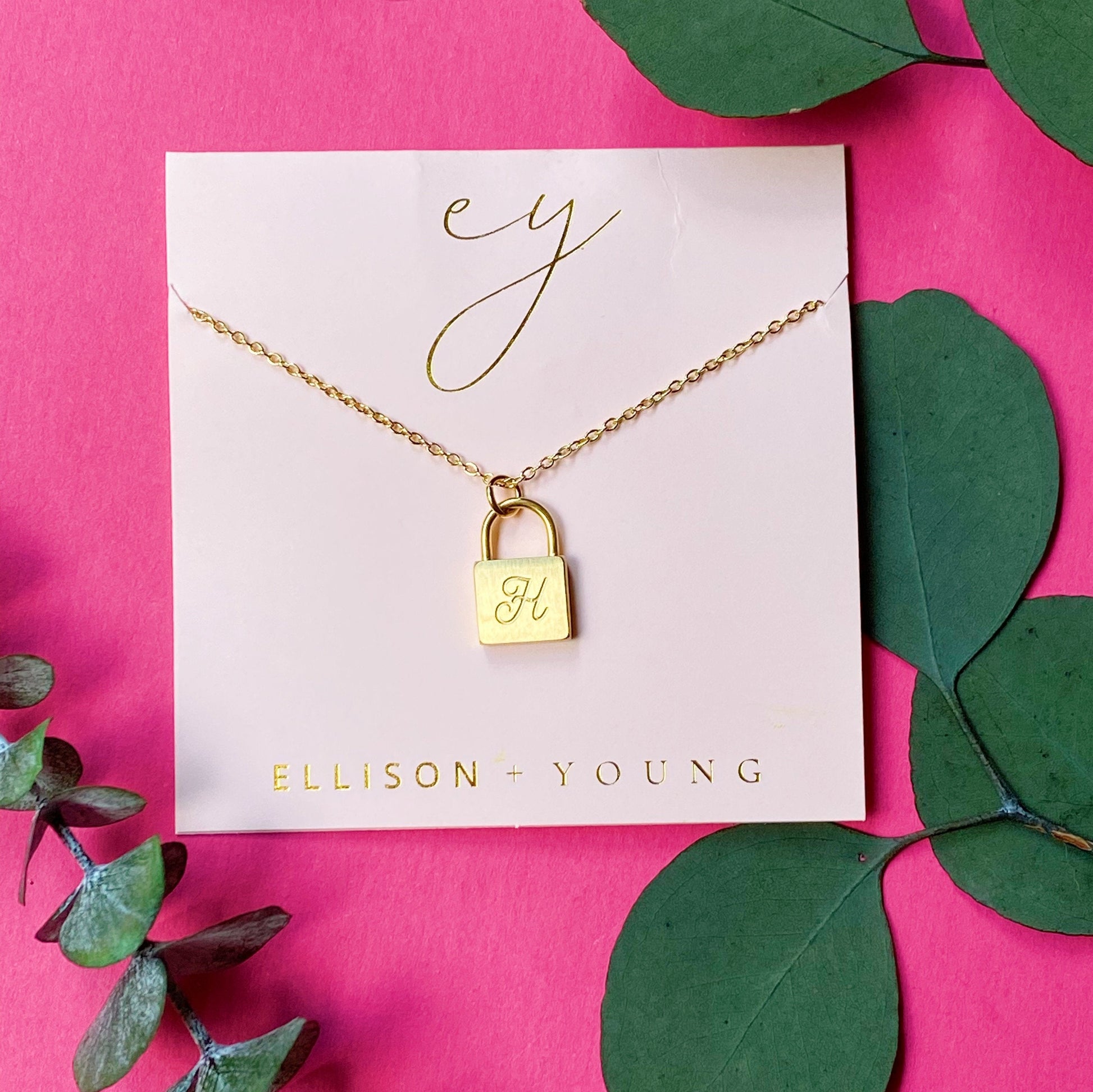 A 'H' initial necklace shown 