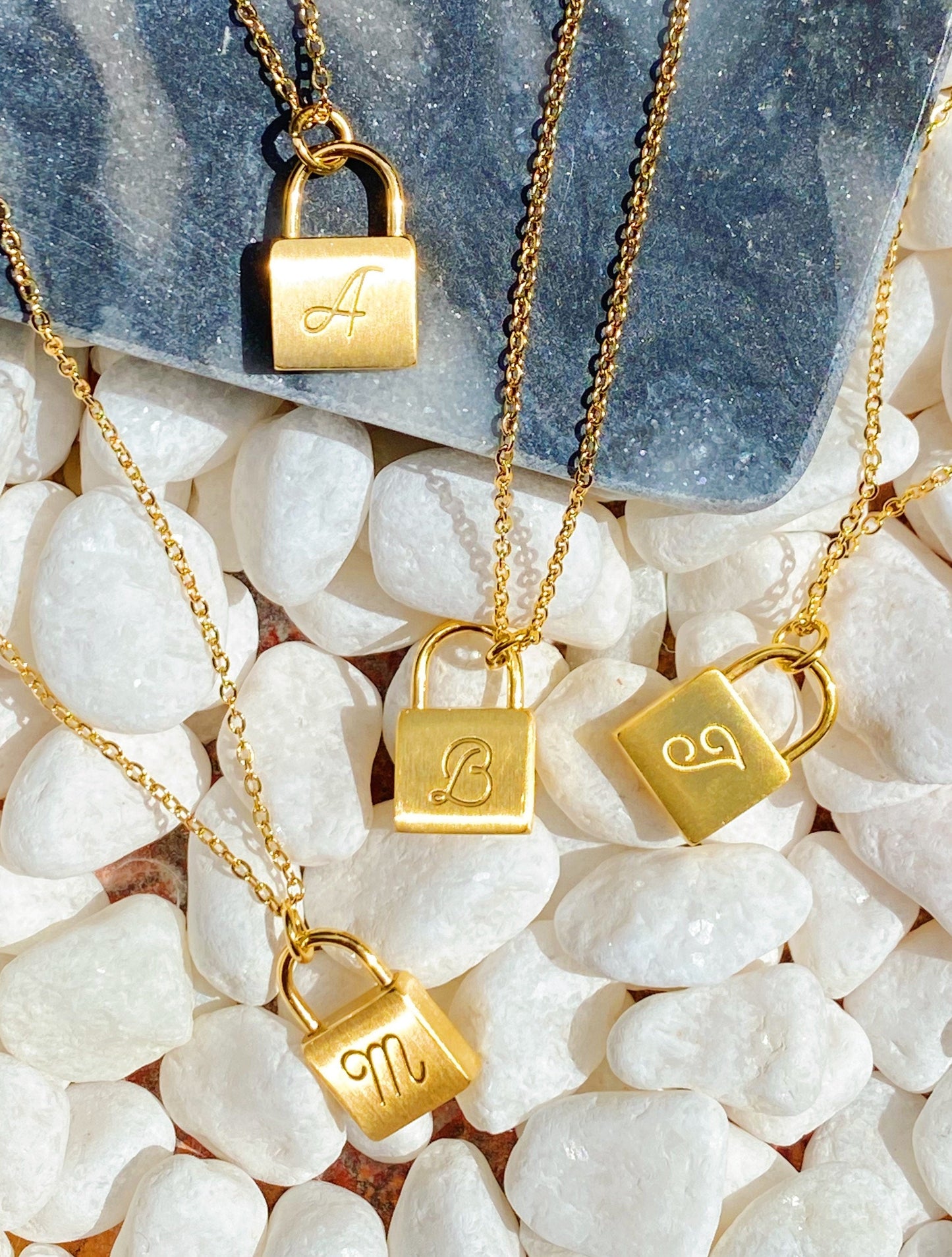 A variety of initials of the necklace shown 